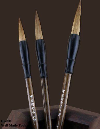 Sumi brushes set on a craft table with tools