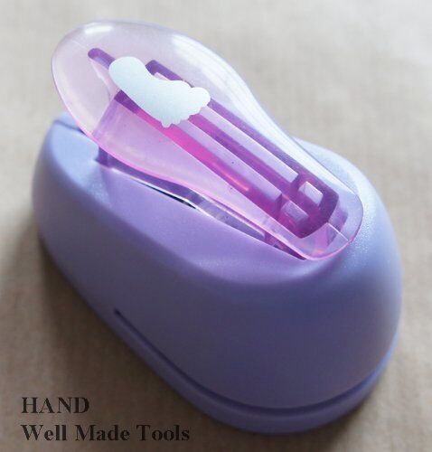 Large craft paper punch in barefoot shape, showing design.
