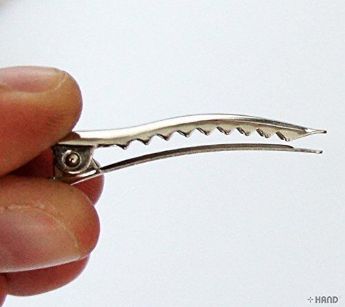 Display of alligator crocodile hair clips in assorted angles.