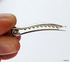 Display of alligator crocodile hair clips in assorted angles.
