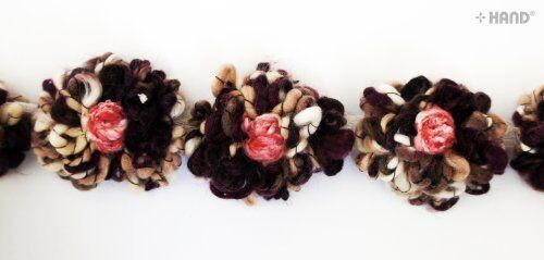 Close-up of decorative soft knitted flower net trim in vibrant colour