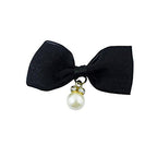 Close-up of black bow trim showcasing gold tone setting and details.