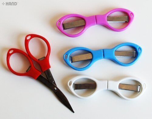 Close-up of the compact travel scissors with safety features