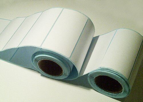 Close-up of smooth white labels on a roll