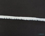 Little white pom pom trim rolled up for easy storage