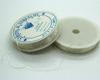 Multiple spools of clear stretchy bead craft thread arranged