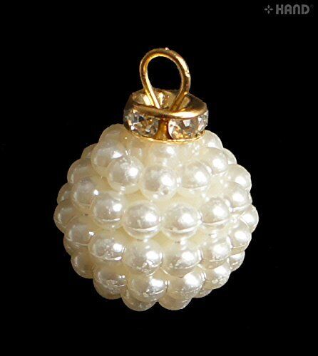 Dangle imitation pearls displayed on a crafting surface.