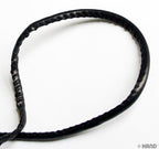 Packaging of black faux leather trim roll with dimensions
