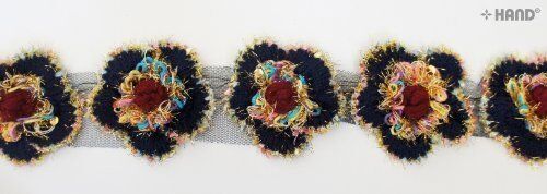Close-up of colourful knitted flowers net trim with sequins