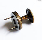 Different angles of vintage gold magnetic press studs displayed.