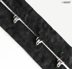 Silver hook and eyes arranged on a black tape background