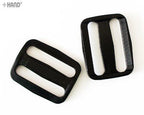 Different angles of black webbing slide buckles for fastening.