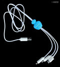 3-in-1 charging cable with LED light on a wooden surface