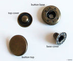 Vintage gold 4-part flat top press stud buttons displayed