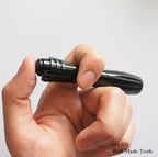 Mini torch in use, illuminating a dark area effectively.