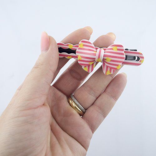 Close-up of two-tone bow on enamelled hairclip