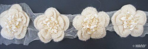 Different angles of the knitted flower with tinsel net trim