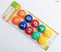 Assorted colours of magnetic numbers 0-9 displayed on a surface