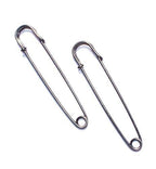 Close-up of a dark copper kilt pin showcasing its design and finish.