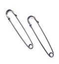 Two dark copper kilt pins displayed on a white background.
