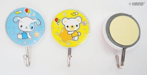 Self adhesive hooks in use, holding children's accessories on a wall.