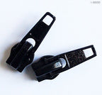 Close-up of NZP17 black zip pulls showing detail and finish