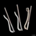 Three metal money clips arranged on a flat surface