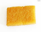 Close-up of a rubber glue applicator block showing texture.
