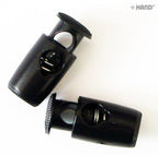 Plastic toggle spring stop cord locks displayed on a white background