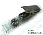 Close-up of a metal badge clip showcasing the snap mechanism.