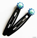 Assorted colours of diamante hair clips displayed together.