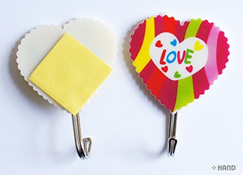 Heart shape self adhesive hooks displayed on a bathroom wall.
