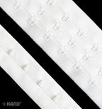 Continuous hook and eye tape in white, plush backed for comfort.