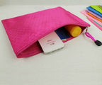 A5 zip file bags arranged on a desk with stationery