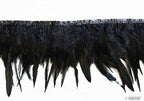 Black duck feather fringe trim displayed on a crafting table.