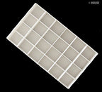 Close-up of the 24 wells in the plastic artists palette box