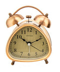 Triangle-shaped vintage style alarm clock in copper tone finish.
