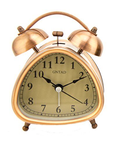 Triangle-shaped vintage style alarm clock in copper tone finish.