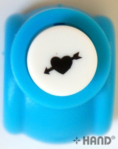 Heart and arrow craft paper punch on a white background.