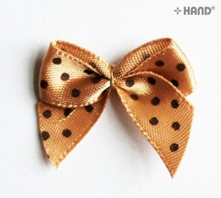 Display of decorative brown ribbon bows with black dots in various arrangements.