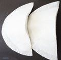 Two pairs of white canvas lined shoulder pads displayed