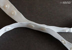 Roll of push button tape showing 18mm width and button design.