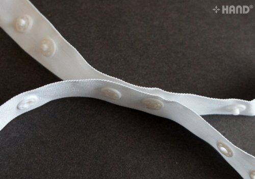Roll of push button tape showing 18mm width and button design.