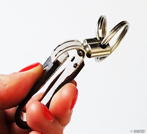 Close-up of a leather wide belt double loop hook keyring buckle showing detail.