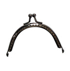 Close-up of the ball kiss clasp lock on the coin purse frame.