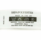 Roll of wash care labels printed with care instructions.