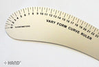 Ruler being used to create curves in a sewing project