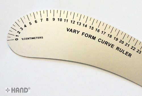 Ruler being used to create curves in a sewing project