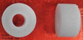 Two blocks of white tailors wax on a wooden surface