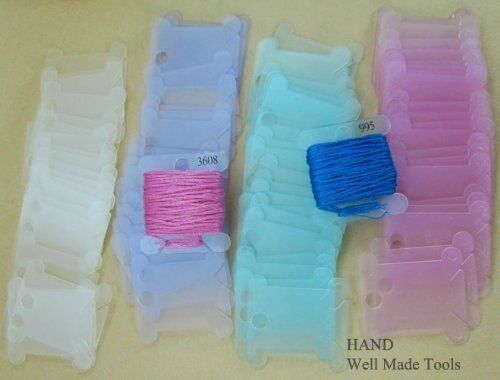 Different colours of thread winders arranged neatly